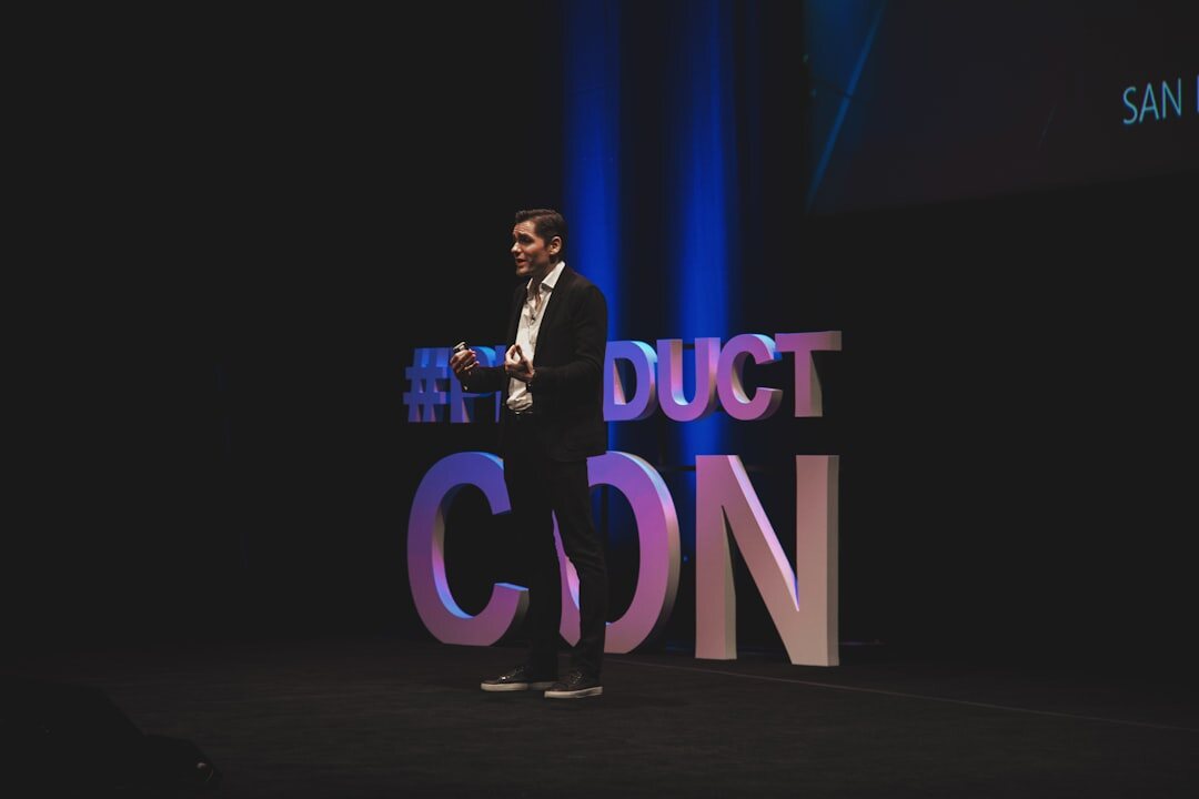 Confident public speaker presenting on stage at a conference