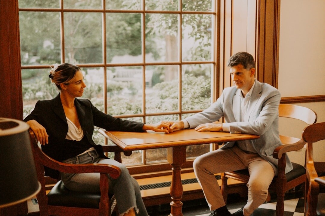 Two professionals in a formal interview session across a table