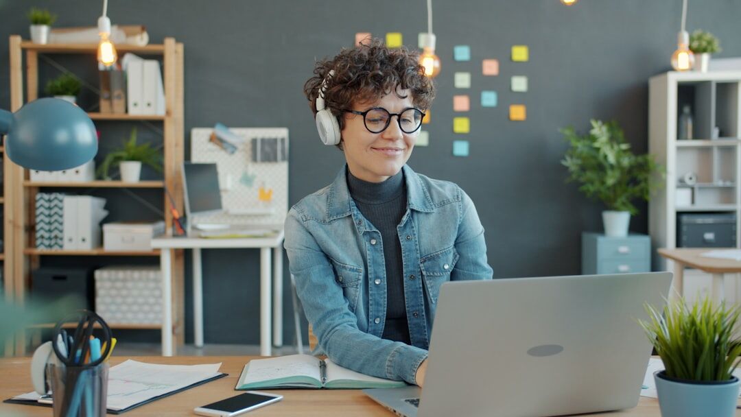 Person working focused on a laptop in a modern clean workspace